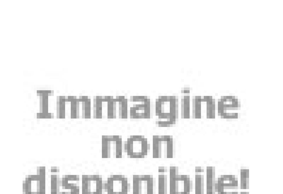 Due persone sorridenti al sole, con bibite in mano, trasmettono gioia e spensieratezza estiva.